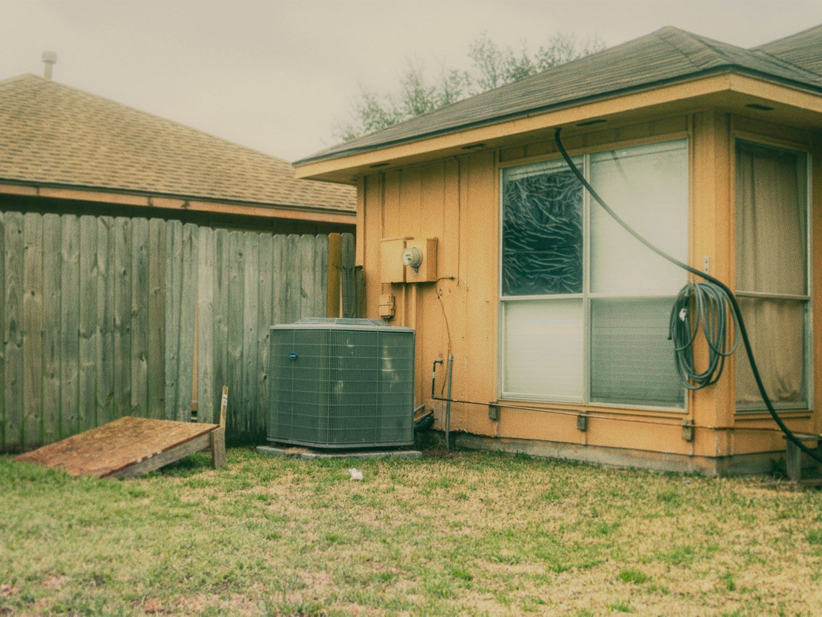 An outdoor air conditioner beside a house