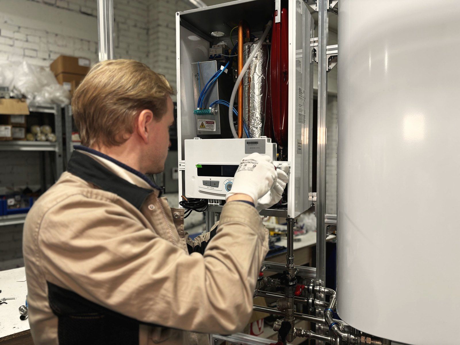 A technician servicing a boiler