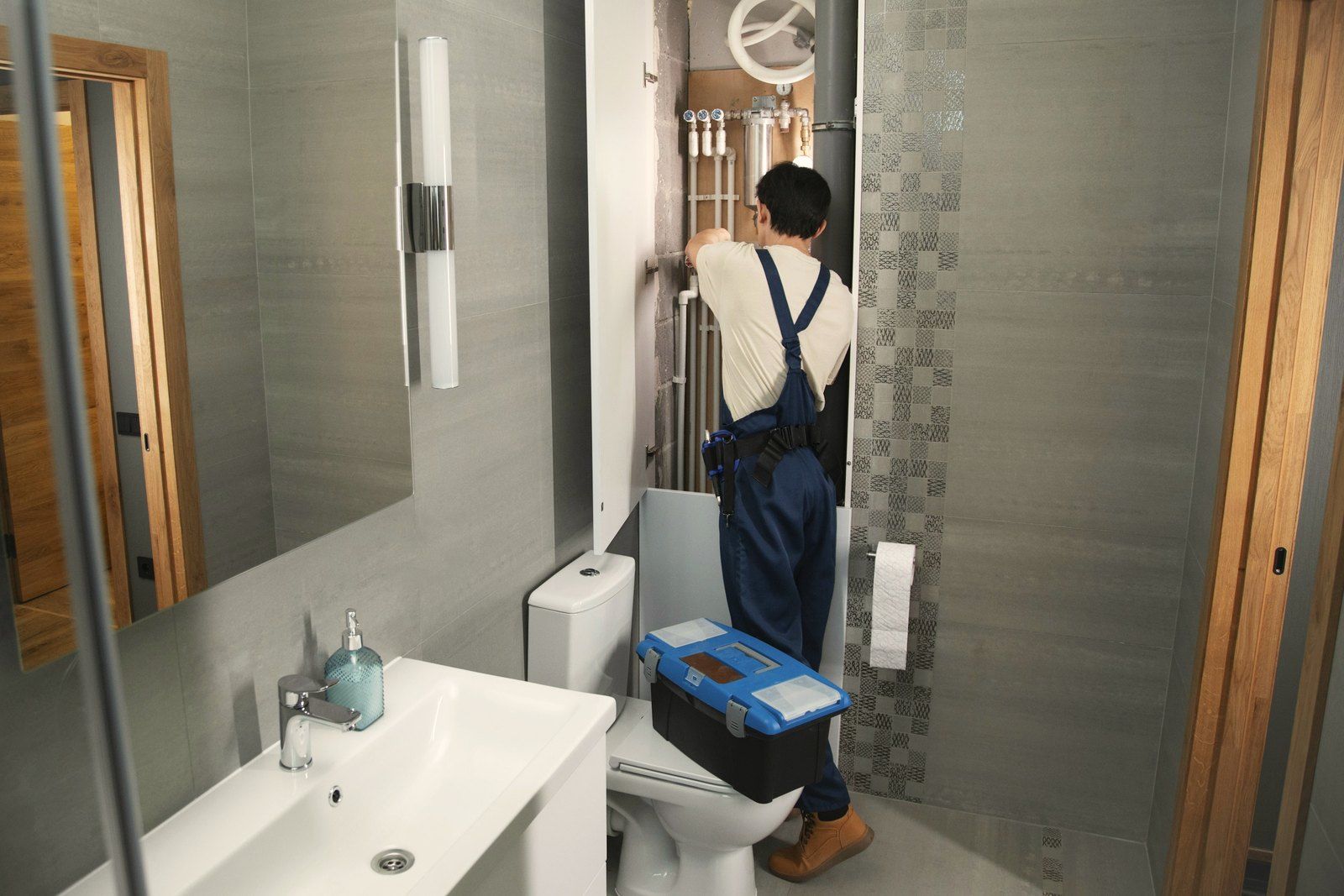 A plumber at work in a bathroom