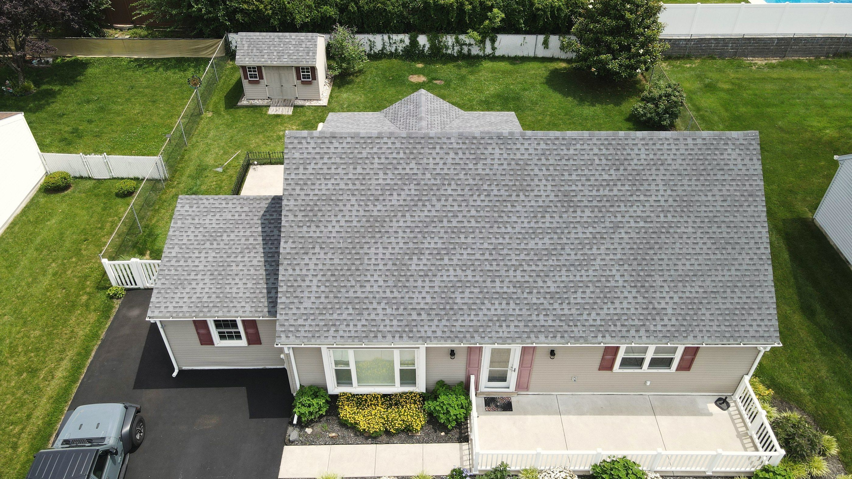 Aerial view of a house with a new gray architectural shingle roof